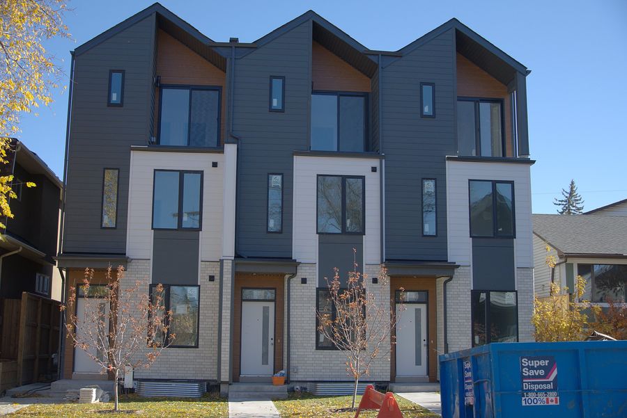 Stacked townhomes, brick and batten fronts, Calgary
