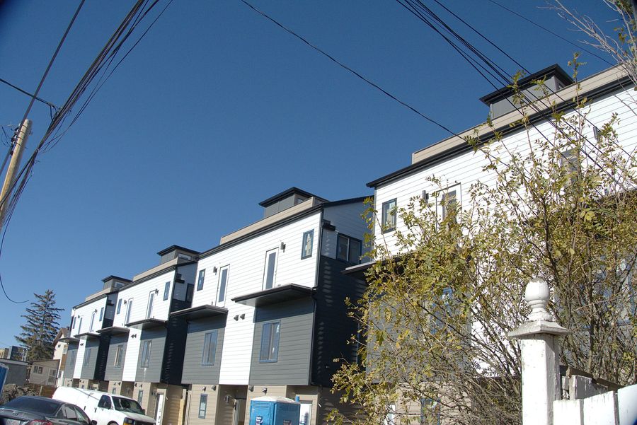 Three storey rows, layered cladding, Calgary